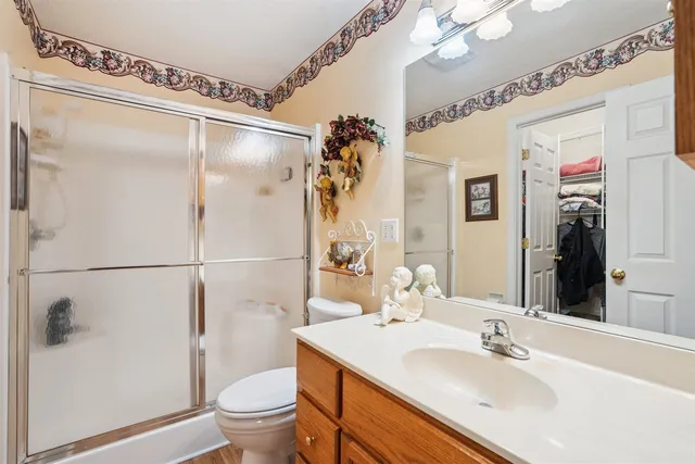 a bathroom with a sink toilet and shower