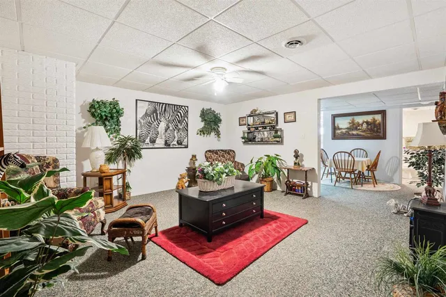 a living room with furniture gym equipment and a rug
