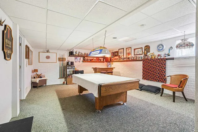 a living room with furniture and a baby crib