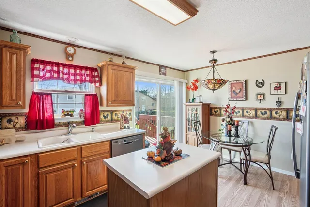 a kitchen with a table chairs stove and wooden floor