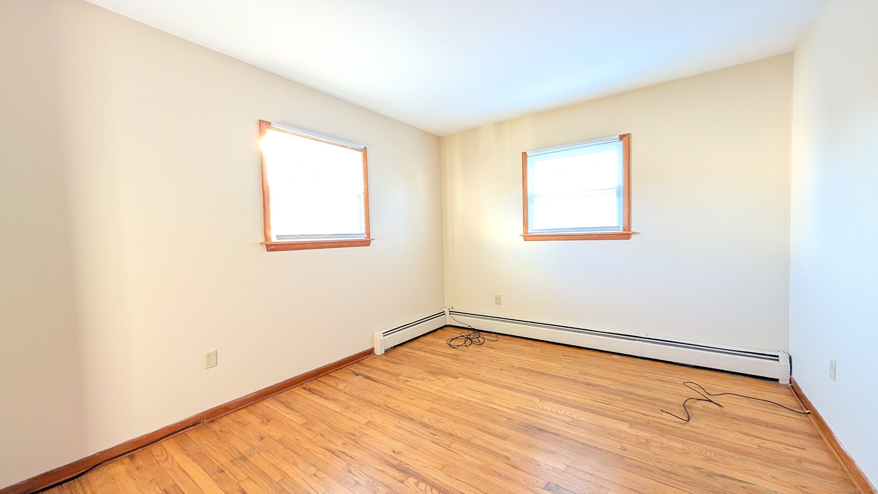 24 Hoyt Street, Unit 2 Danbury, CT 06810 - Photo 19 of 20 a view of an empty room with wooden floor and a window