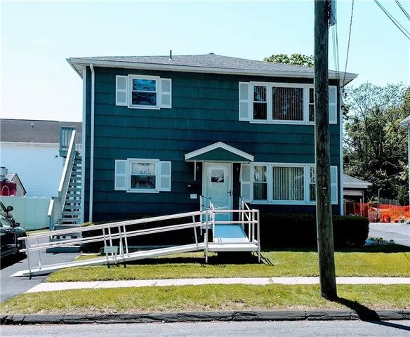 a view of a house with swimming pool next to a yard