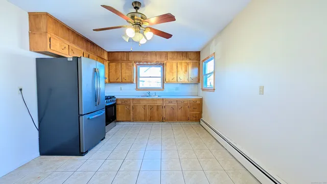 a kitchen with stainless steel appliances a refrigerator and a stove