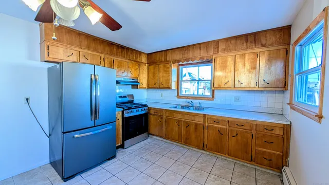 a kitchen with stainless steel appliances granite countertop a refrigerator and a sink