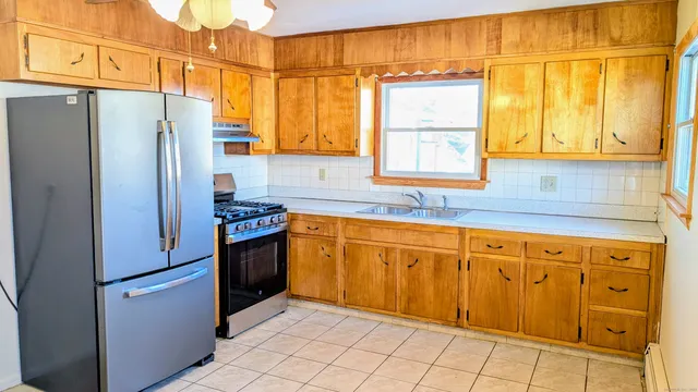 a kitchen with stainless steel appliances granite countertop a refrigerator and a sink