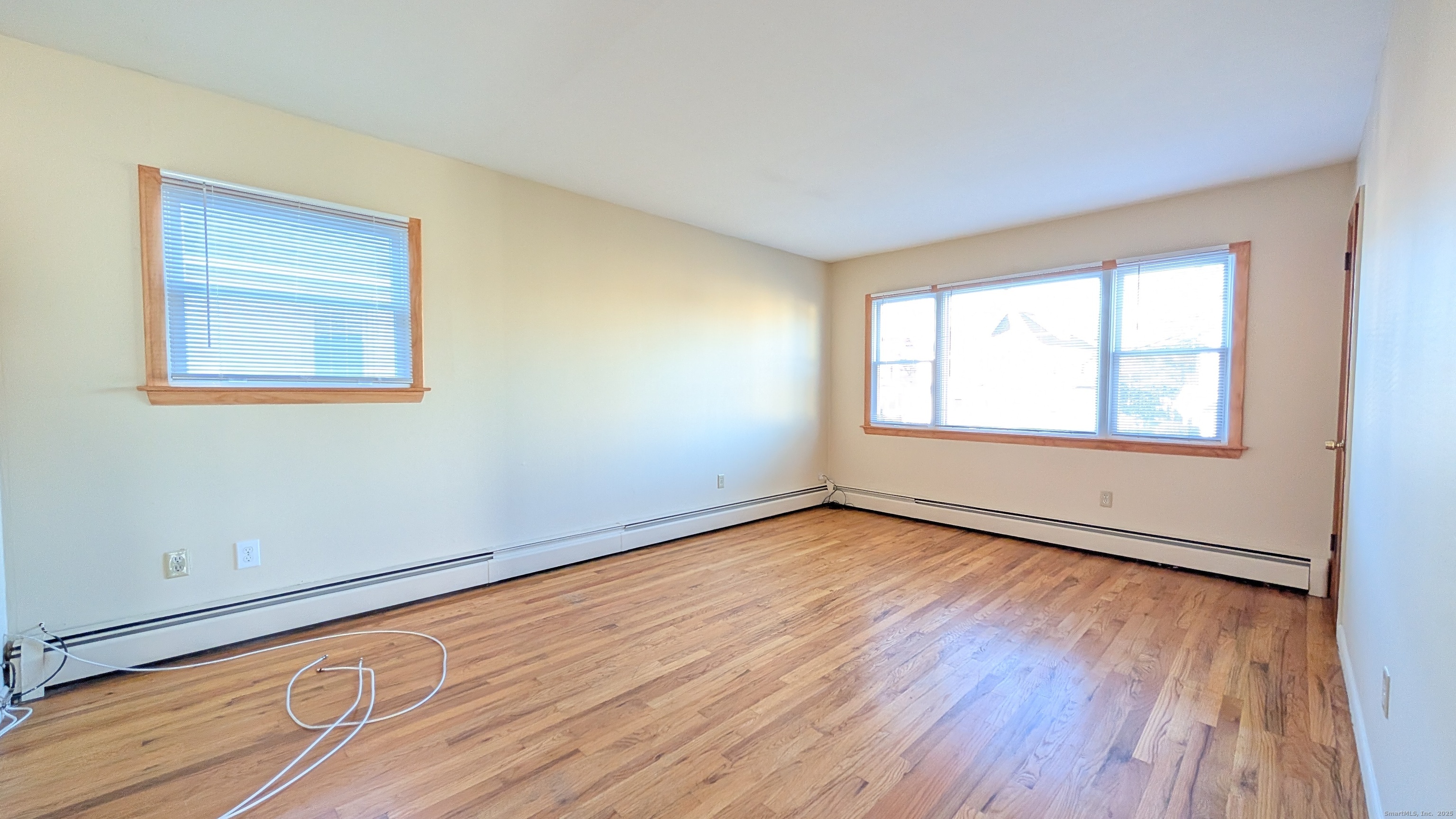 24 Hoyt Street, Unit 2 Danbury, CT 06810 - Photo 10 of 20 a view of an empty room with wooden floor and a window