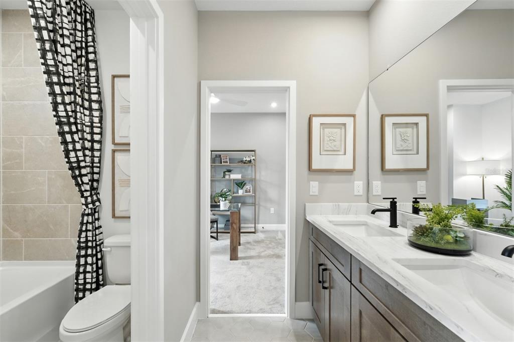 1752 Headland Loop Celebration, FL 34747 - Photo 16 of 31 a bathroom with a sink a toilet and shower