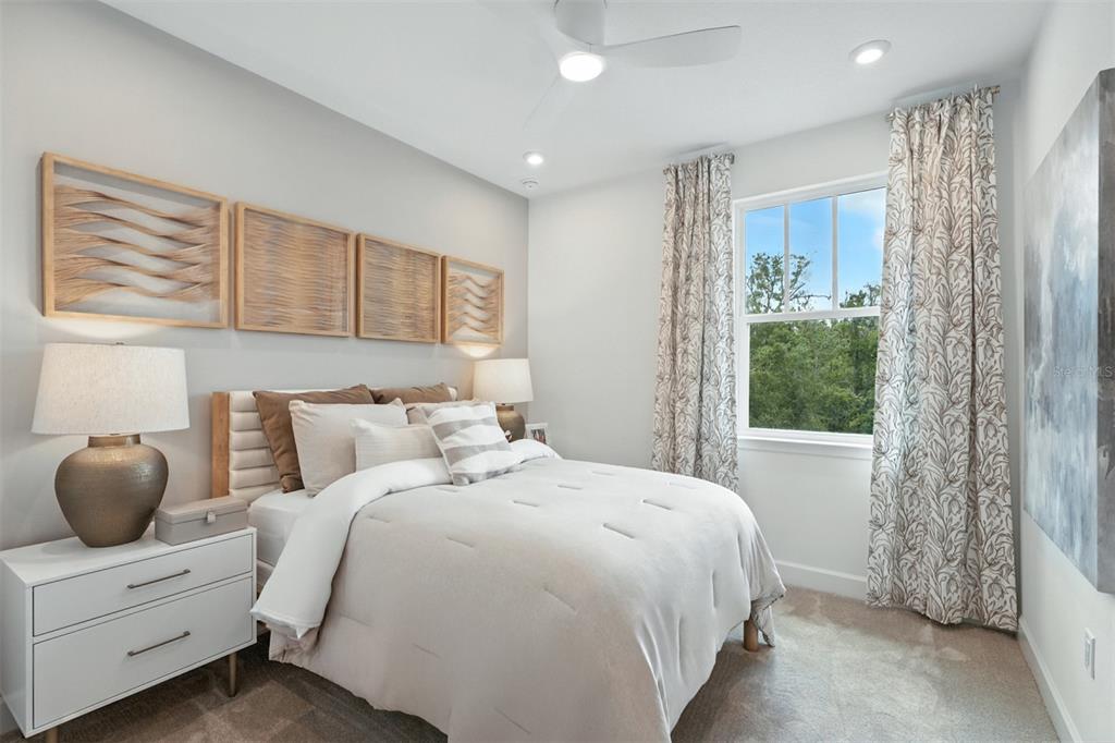 1752 Headland Loop Celebration, FL 34747 - Photo 17 of 31 a bedroom with a large bed and large window