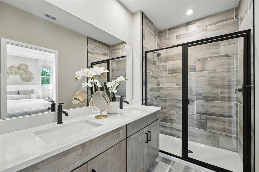 1752 Headland Loop Celebration, FL 34747 - Photo 19 of 31 a bathroom with a shower sink and mirror