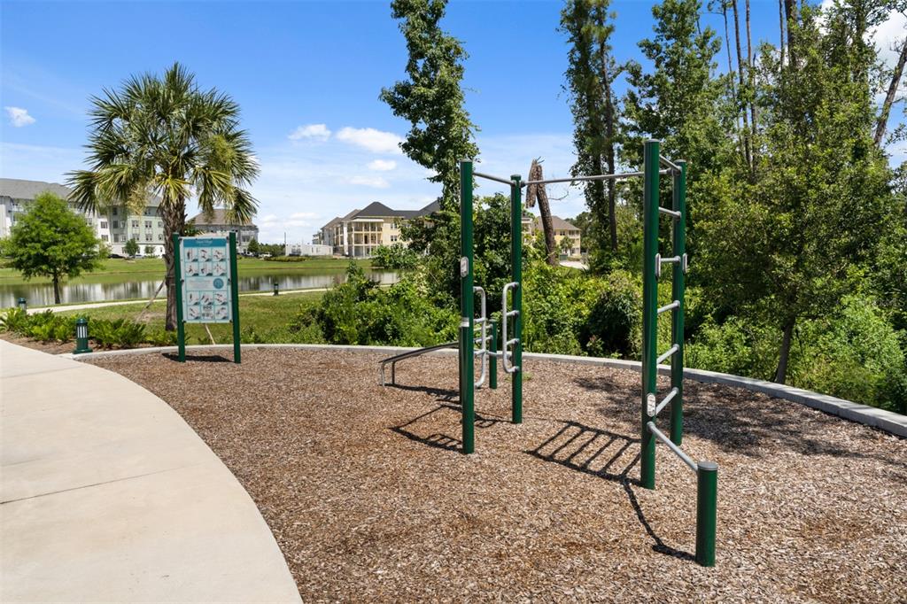 1752 Headland Loop Celebration, FL 34747 - Photo 25 of 31 a view of a street with a bench and trees