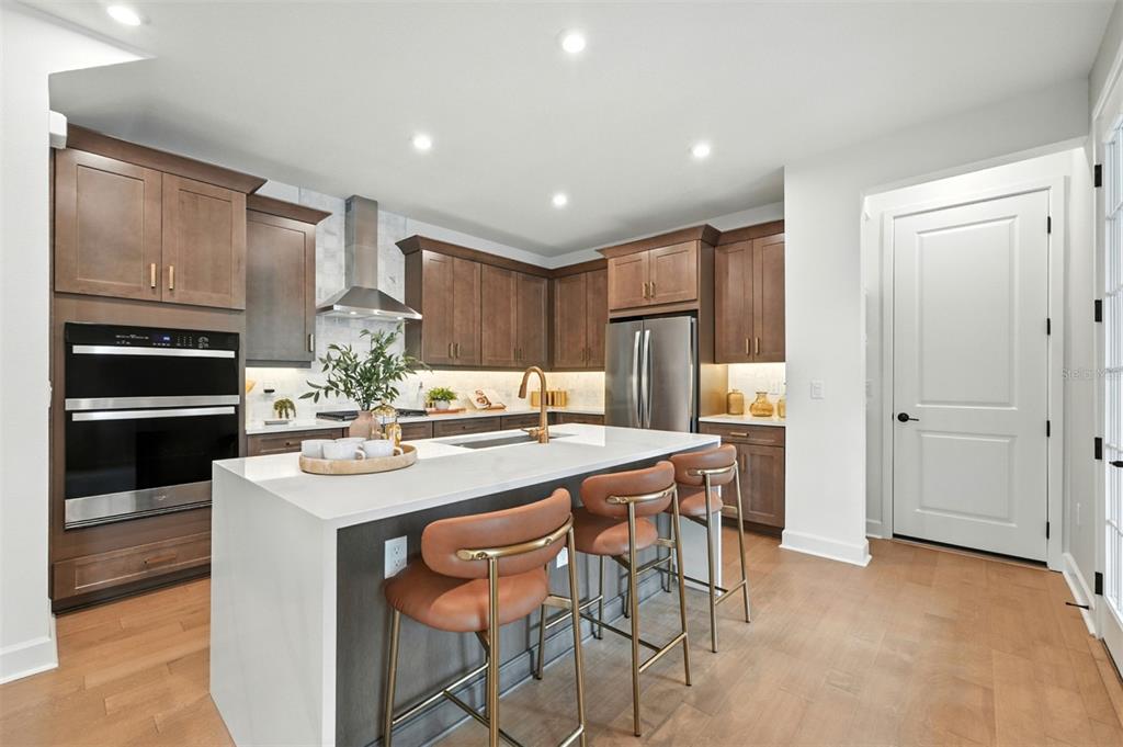1752 Headland Loop Celebration, FL 34747 - Photo 4 of 31 a kitchen with stainless steel appliances kitchen island granite countertop a sink and cabinets