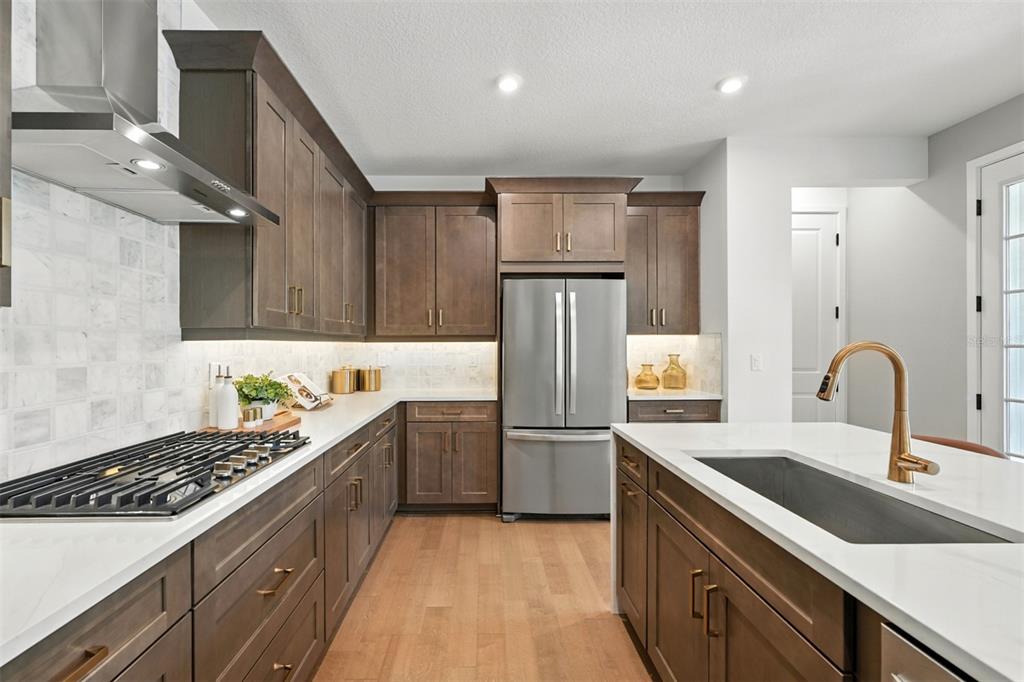 1752 Headland Loop Celebration, FL 34747 - Photo 5 of 31 a kitchen with a sink cabinets and stainless steel appliances