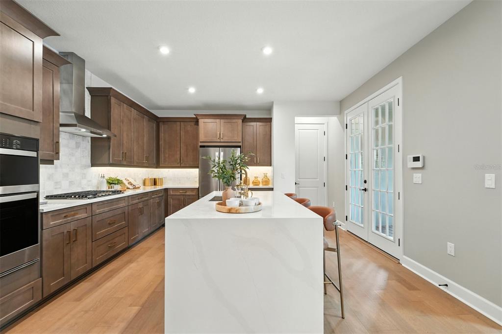 1752 Headland Loop Celebration, FL 34747 - Photo 6 of 31 a kitchen with kitchen island a sink stainless steel appliances and cabinets