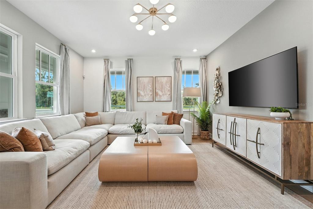 1752 Headland Loop Celebration, FL 34747 - Photo 7 of 31 a living room with furniture and a flat screen tv