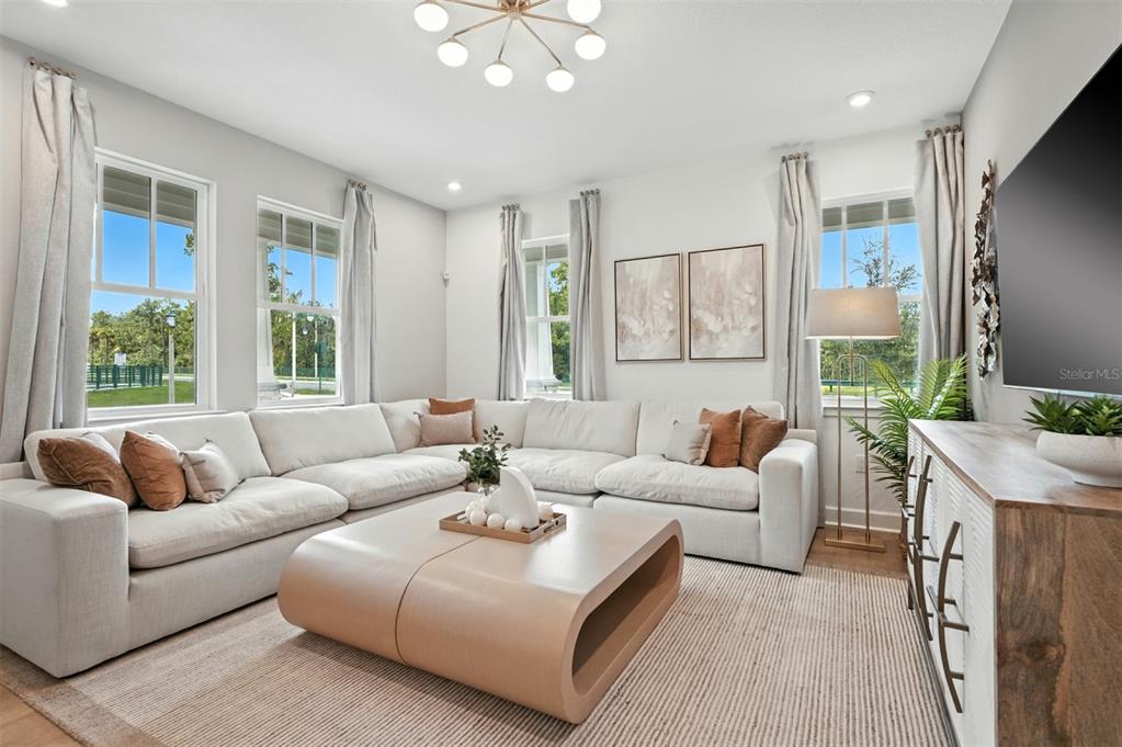 1752 Headland Loop Celebration, FL 34747 - Photo 8 of 31 a living room with furniture and a large window