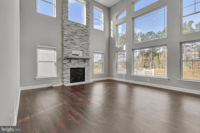 a view of a kitchen with wooden floor and a window