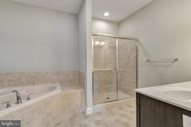 a view of an empty room with chandelier fan