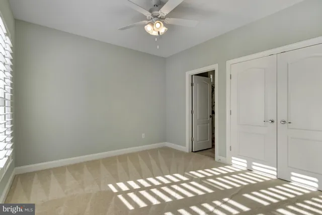 an empty room with fan and a ceiling fan