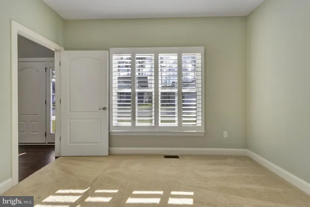 a view of an empty room with windows
