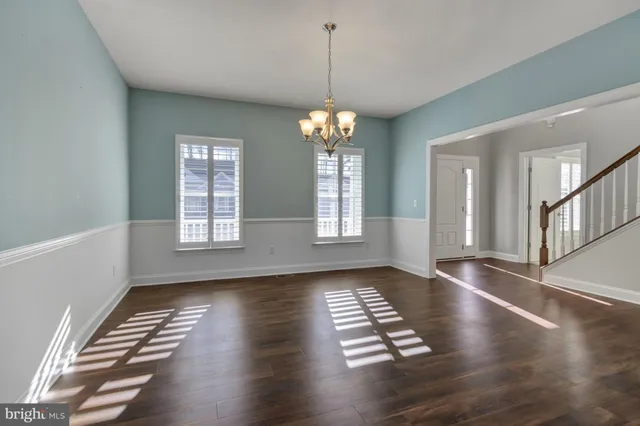 a large white kitchen with a large window