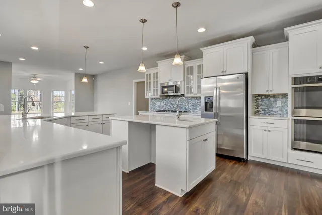 a kitchen with cabinets and stainless steel appliances