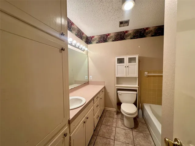 a bathroom with a toilet a sink and shower