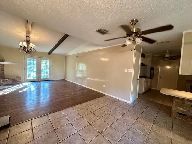a view of a livingroom with a ceiling fan and window