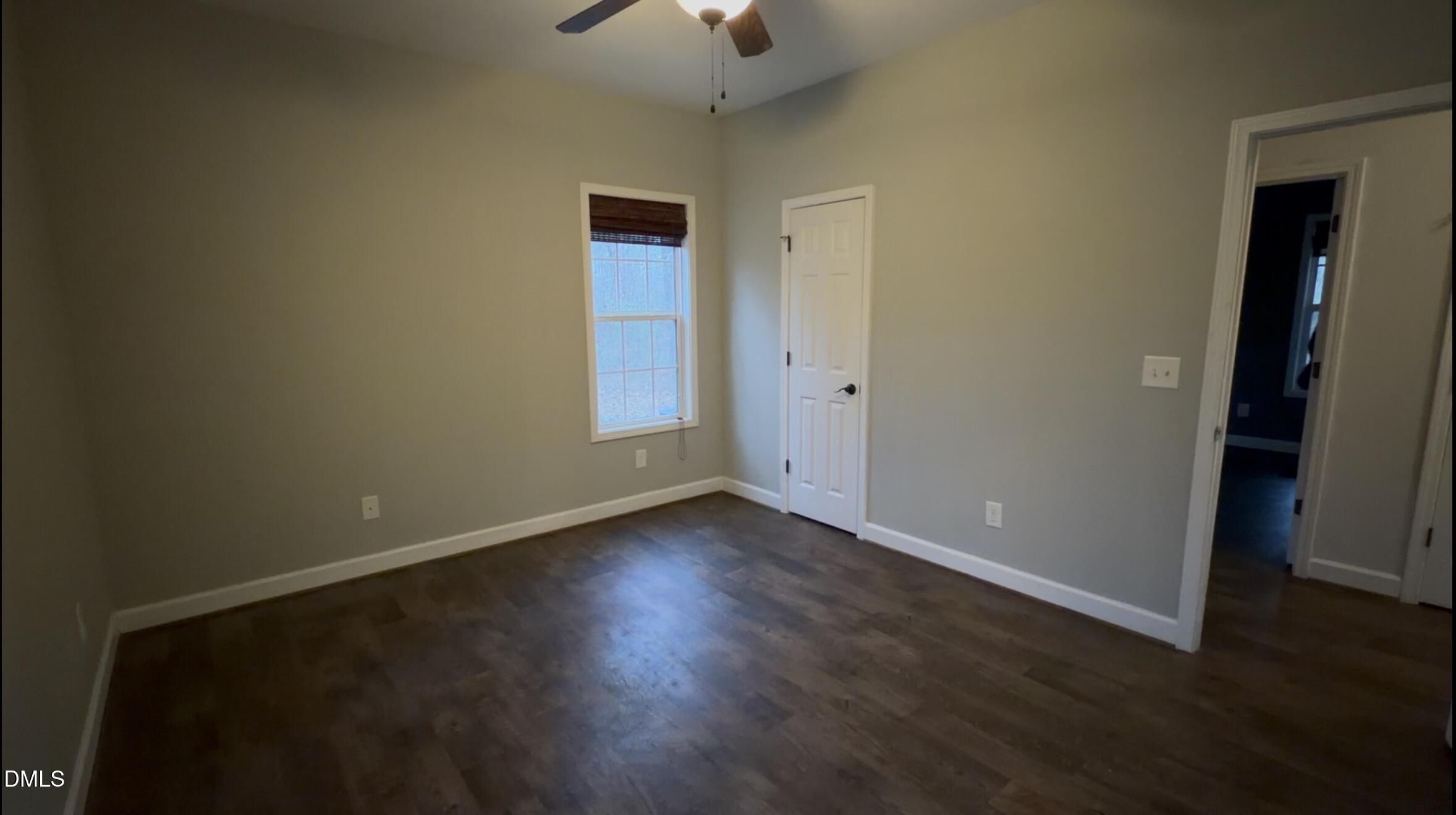 2733 Will Lucas Road Spring Lake, NC 28390 - Photo 15 of 21 an empty room with wooden floor and windows