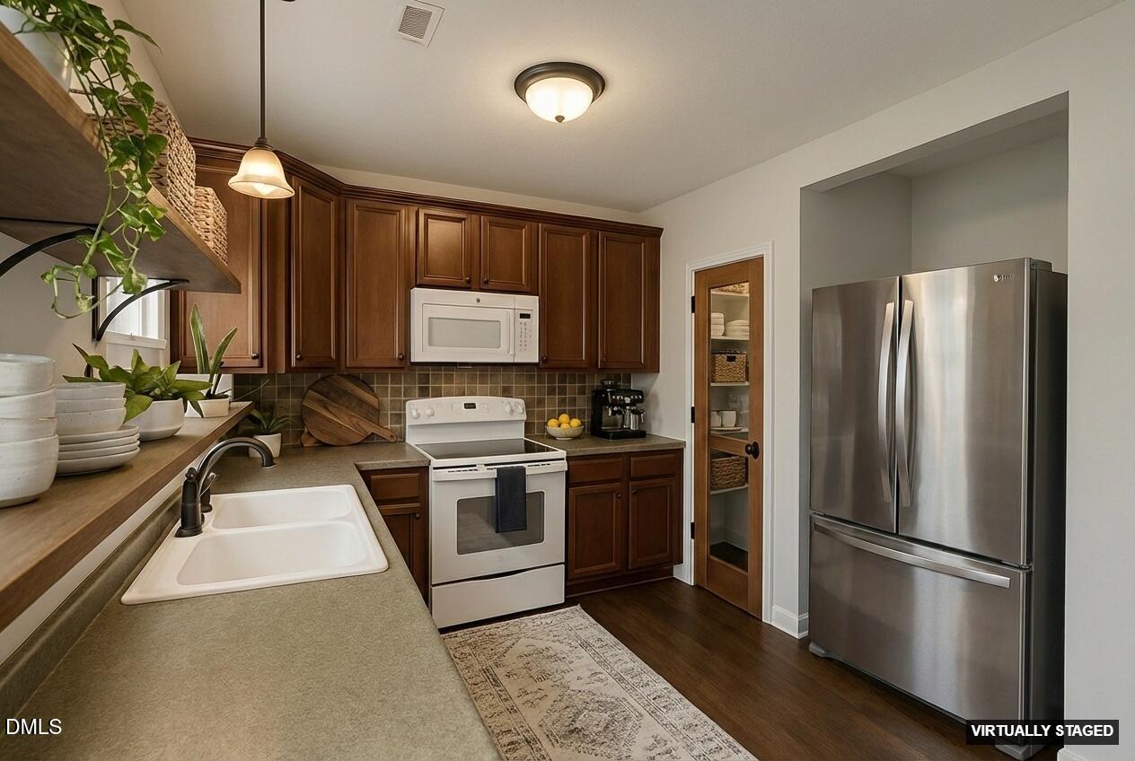 2733 Will Lucas Road Spring Lake, NC 28390 - Photo 8 of 25 a kitchen with stainless steel appliances granite countertop a refrigerator a stove a sink and a microwave