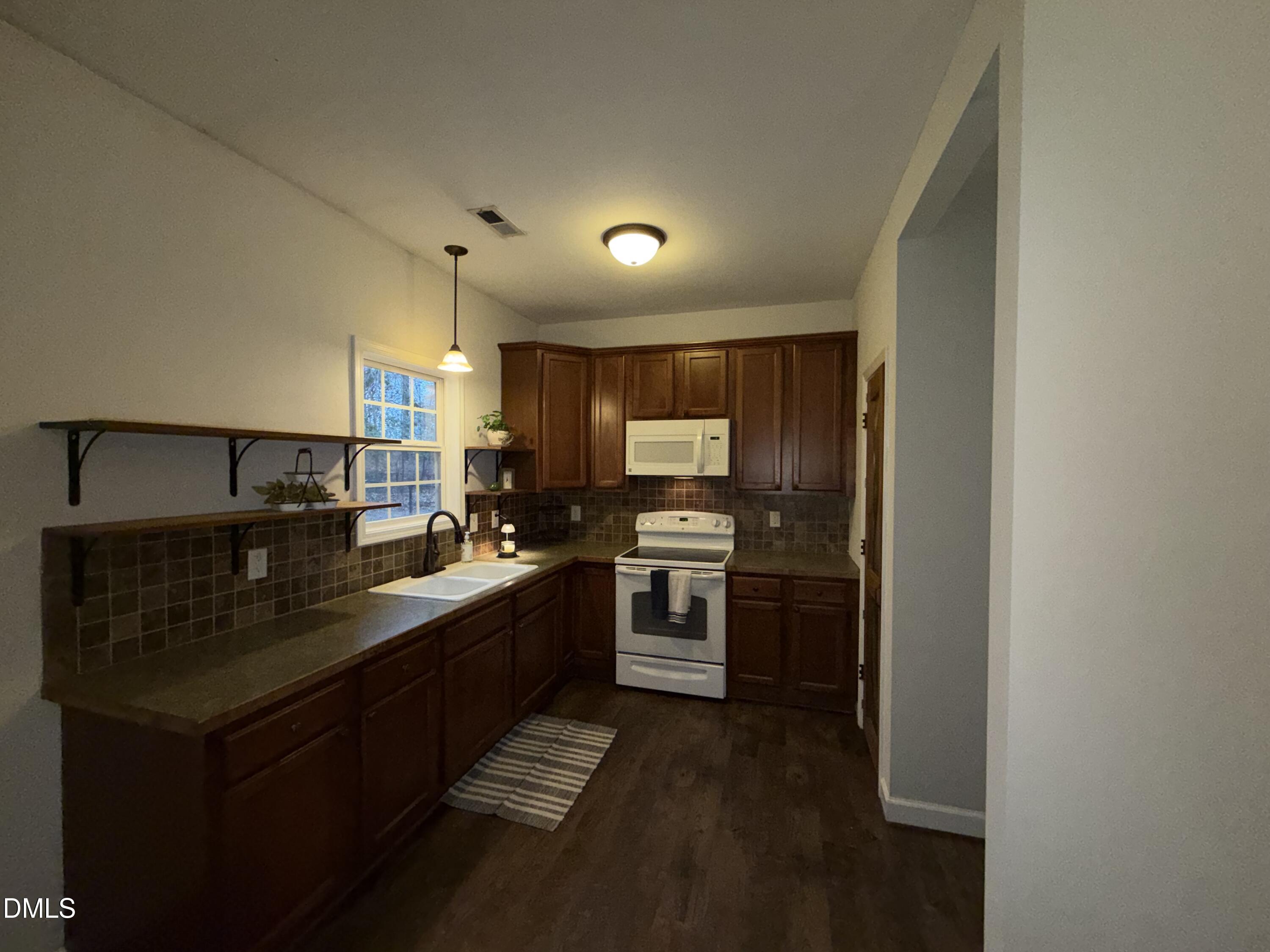 2733 Will Lucas Road Spring Lake, NC 28390 - Photo 8 of 21 a kitchen with kitchen island granite countertop a sink stove and refrigerator