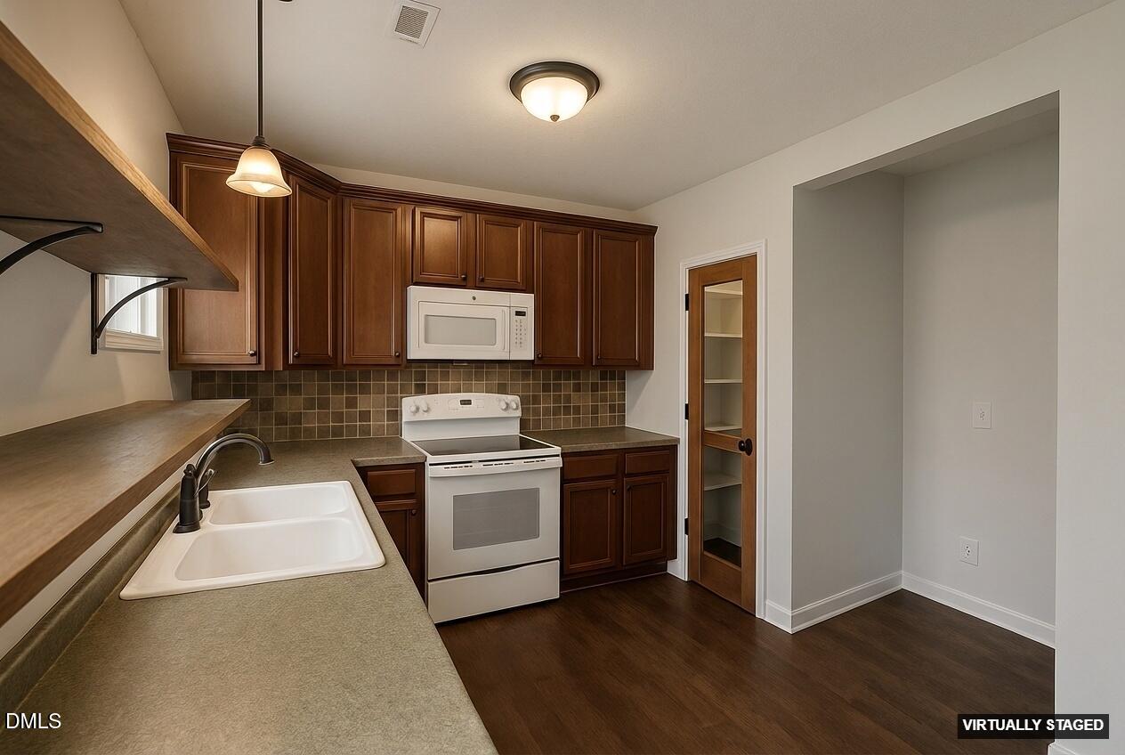 2733 Will Lucas Road Spring Lake, NC 28390 - Photo 9 of 25 a kitchen with stainless steel appliances granite countertop a stove a sink and a refrigerator
