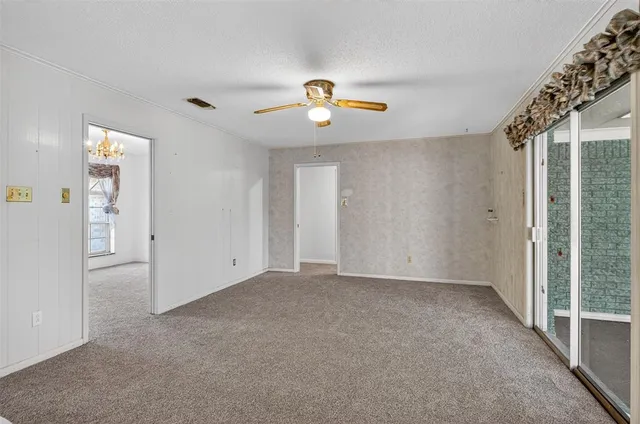 a view of a livingroom with wooden floor and a chandelier