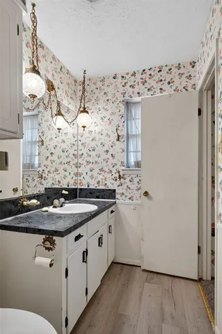 an empty room with closet and a chandelier fan