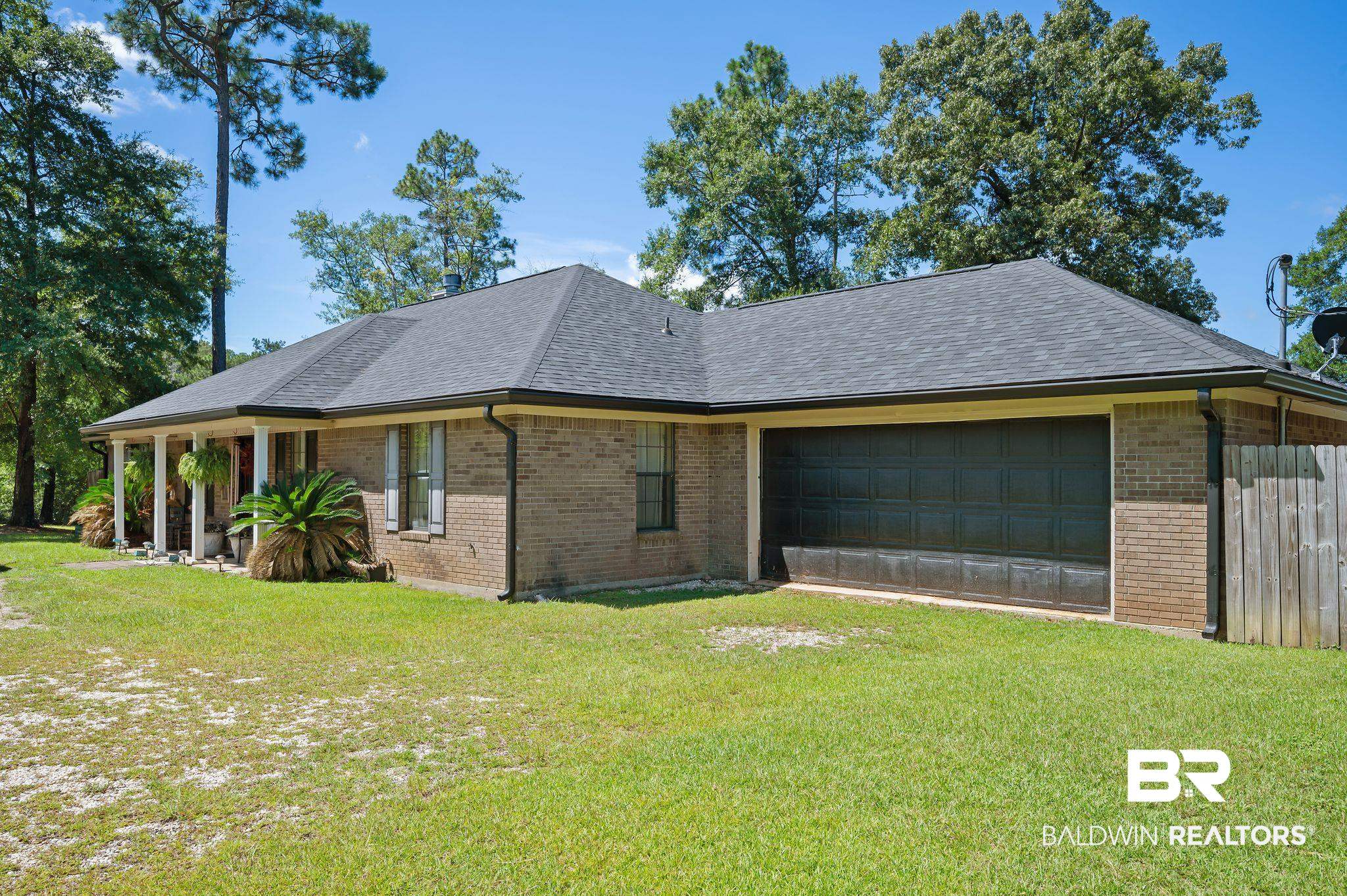 52923 Ammons Road Perdido, AL 36562 - Photo 1 of 35 View of property exterior with brick siding, a shingled roof, and an attached garage