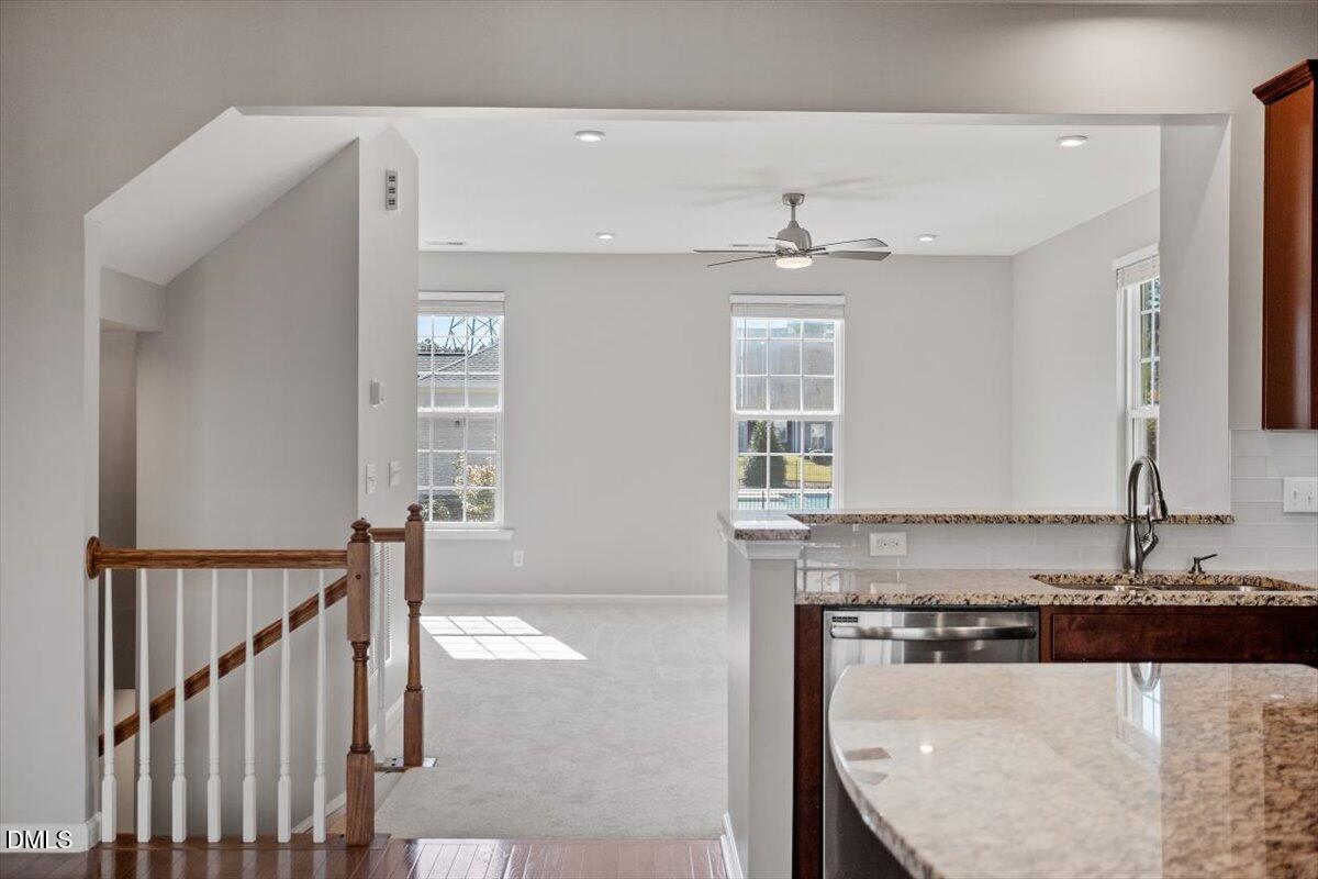 117 Brier Ridge Drive Durham, NC 27703 - Photo 14 of 29 a view of a kitchen with kitchen island a sink wooden floor and a fireplace
