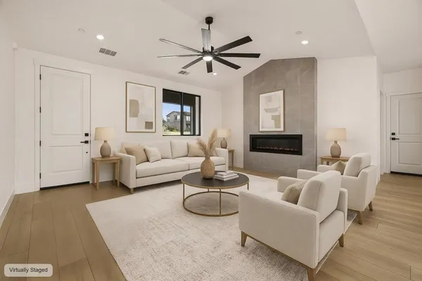 a living room with furniture a ceiling fan and a rug