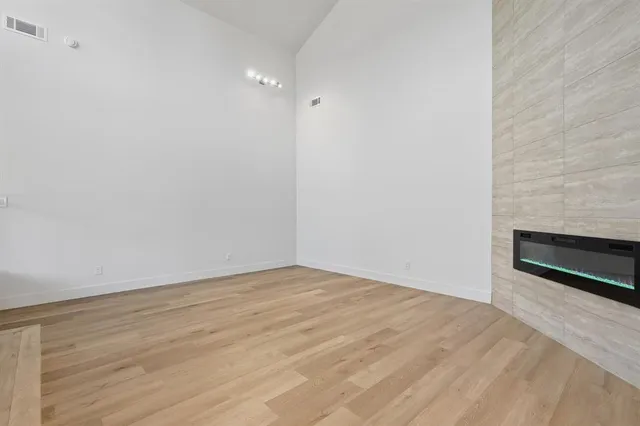 a big room with wooden floor and windows