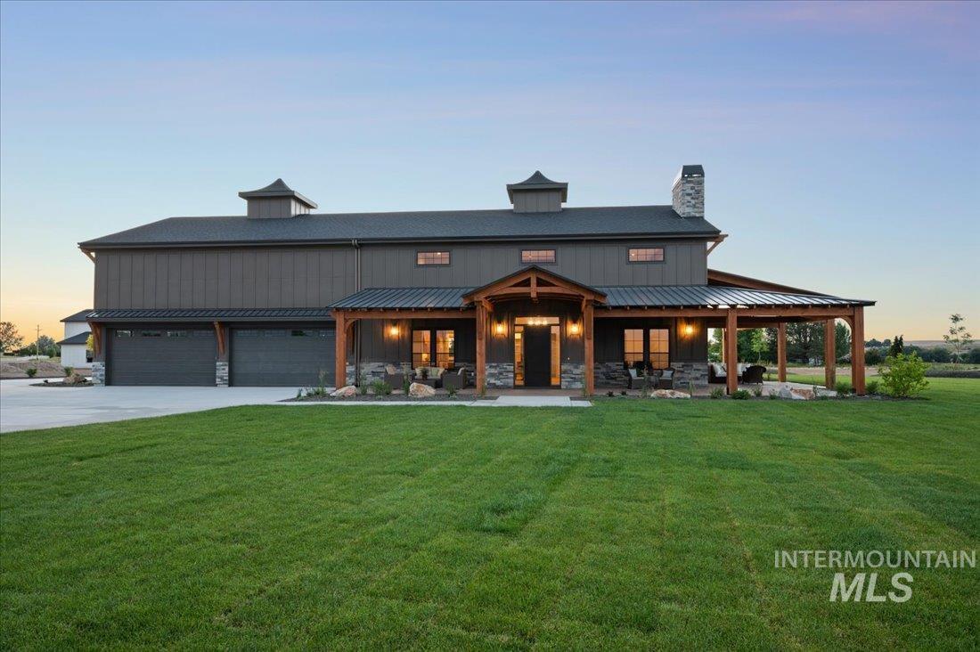 8860 Kemp Middleton, ID 83644 - Photo 50 of 50 View of front of house with a front lawn, a chimney, concrete driveway, a garage, and stone siding