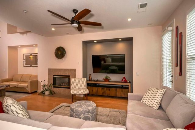 a living room with furniture a fireplace and a flat screen tv