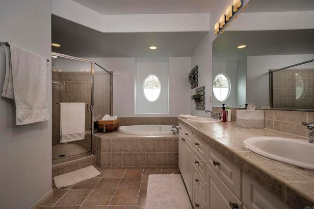 a spacious bathroom with a bathtub sink and mirror