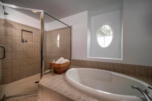 a bathroom with a bathtub and a shower