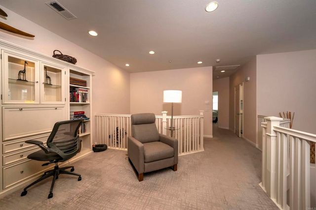 a livingroom with workspace and a couch