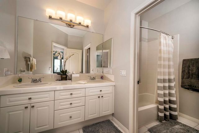 a en suite bathroom with double sink and a mirror
