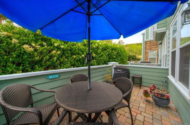 a view of balcony with furniture and umbrella