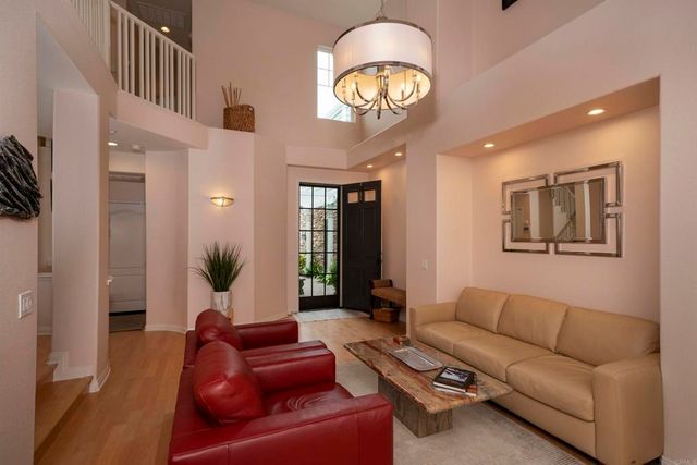 a living room with furniture and a large mirror