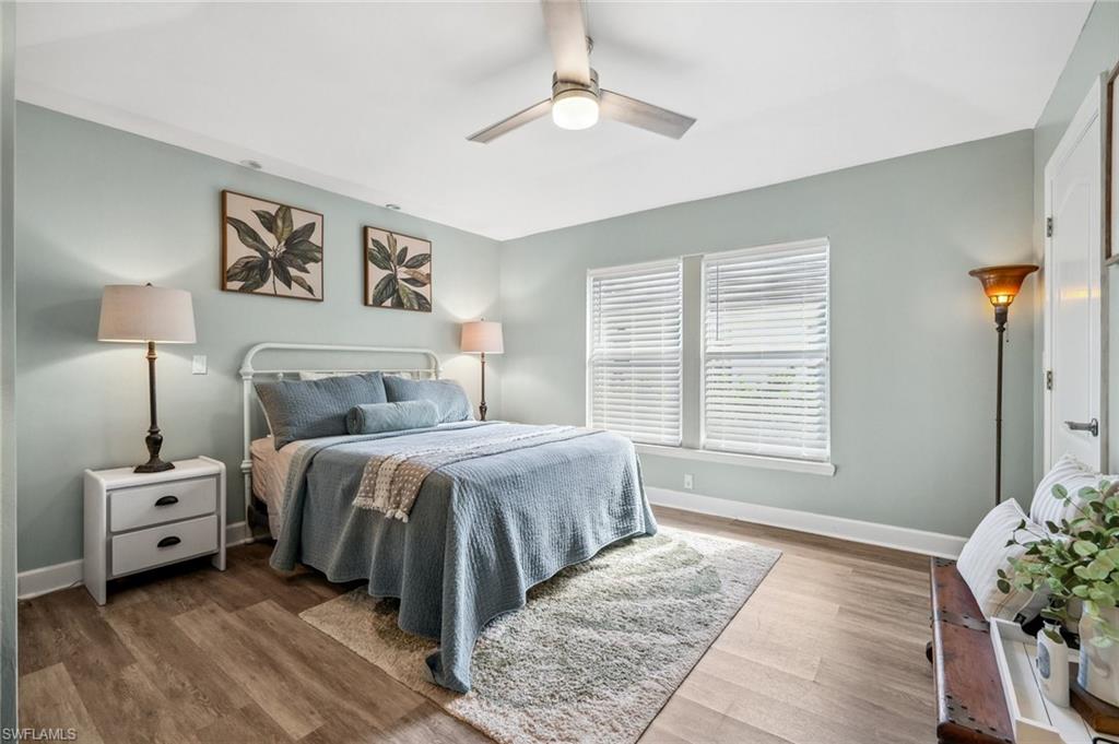 6857 Mill Run Road Naples, FL 34109 - Photo 32 of 49 Bedroom featuring ceiling fan, baseboards, and wood finished floors