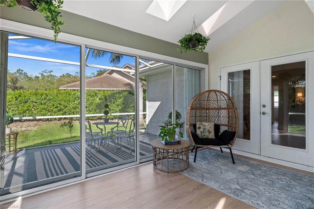 6857 Mill Run Road Naples, FL 34109 - Photo 42 of 49 Unfurnished sunroom with vaulted ceiling with skylight and french doors
