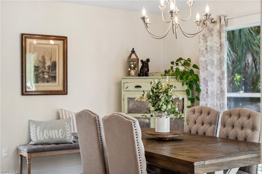 6857 Mill Run Road Naples, FL 34109 - Photo 9 of 49 Dining room featuring a notable chandelier