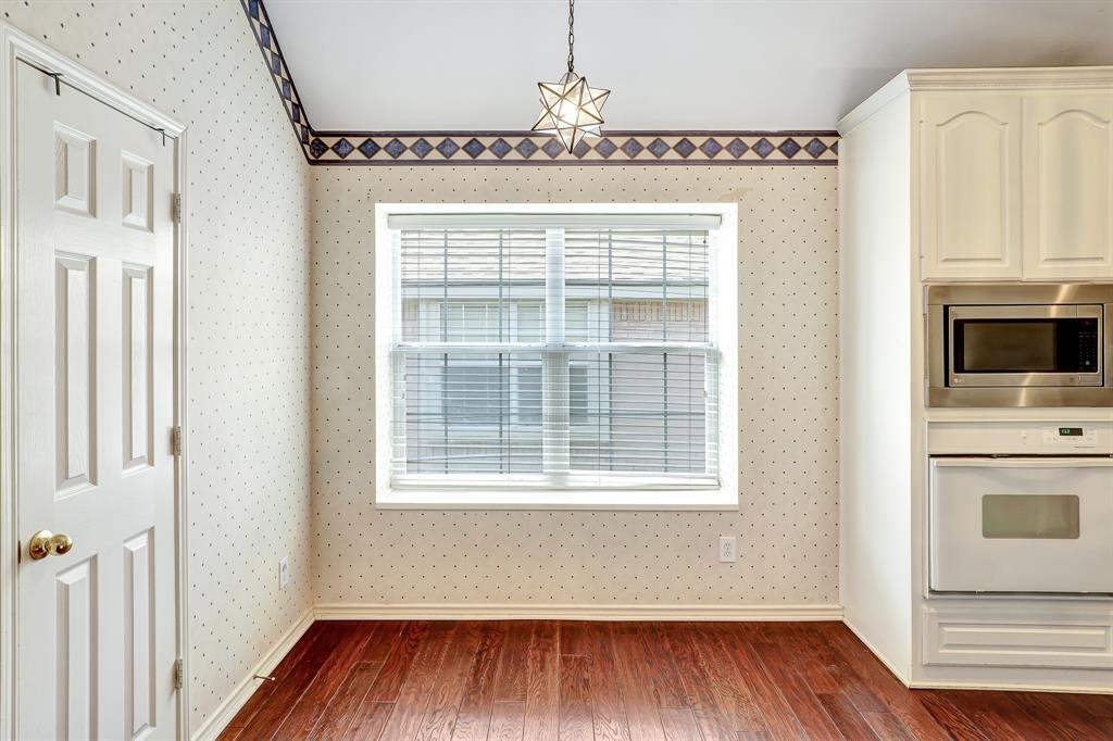 1315 Ballantrae Drive Allen, TX 75013 - Photo 12 of 26 a view of a kitchen with wooden floor and a fireplace