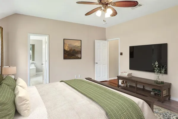 a bedroom with a bed and a flat screen tv
